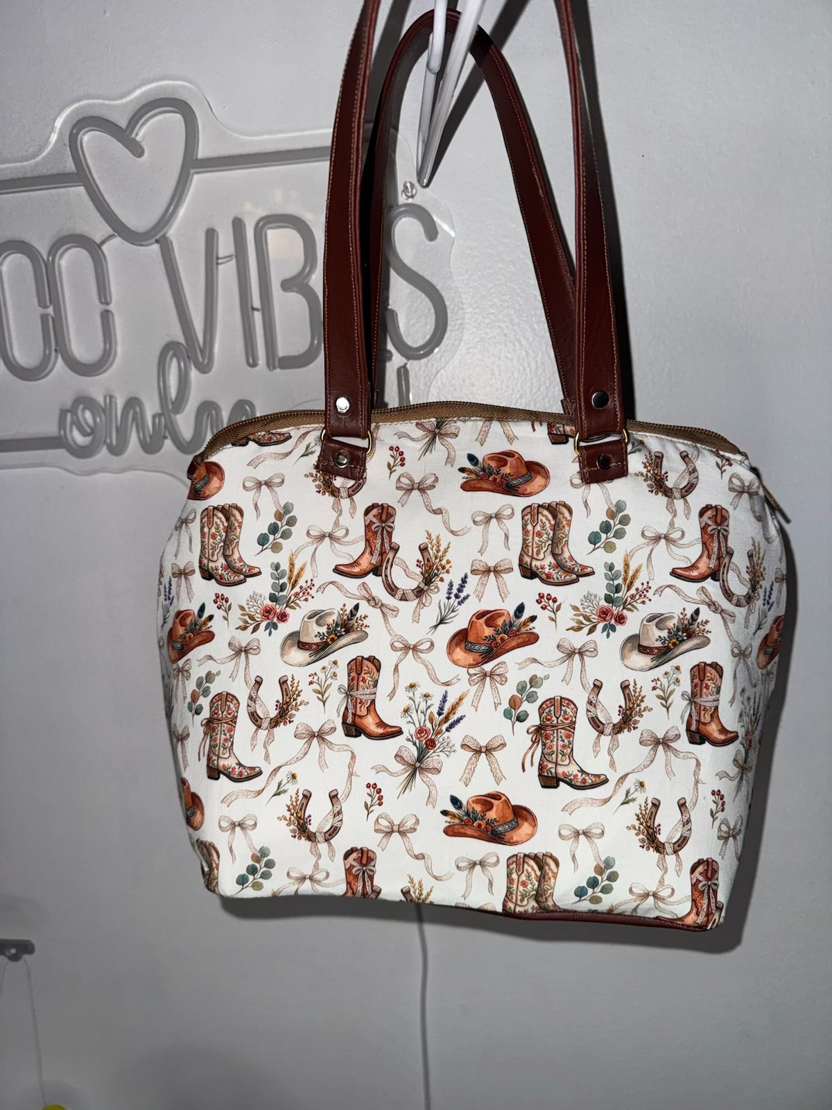 Structured domed western purse in cowgirl print, front view