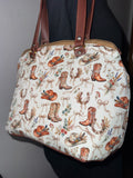 Handmade cowgirl western handbag with cowboy boots, horseshoe, and floral print