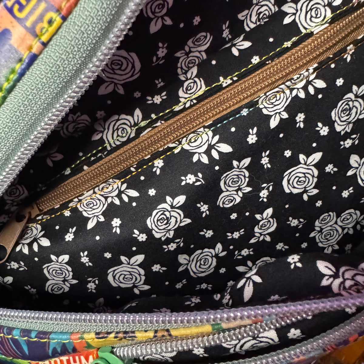 Cryptid fanny pack shown from the front with Bigfoot, Mothman, and Nessie stamp print