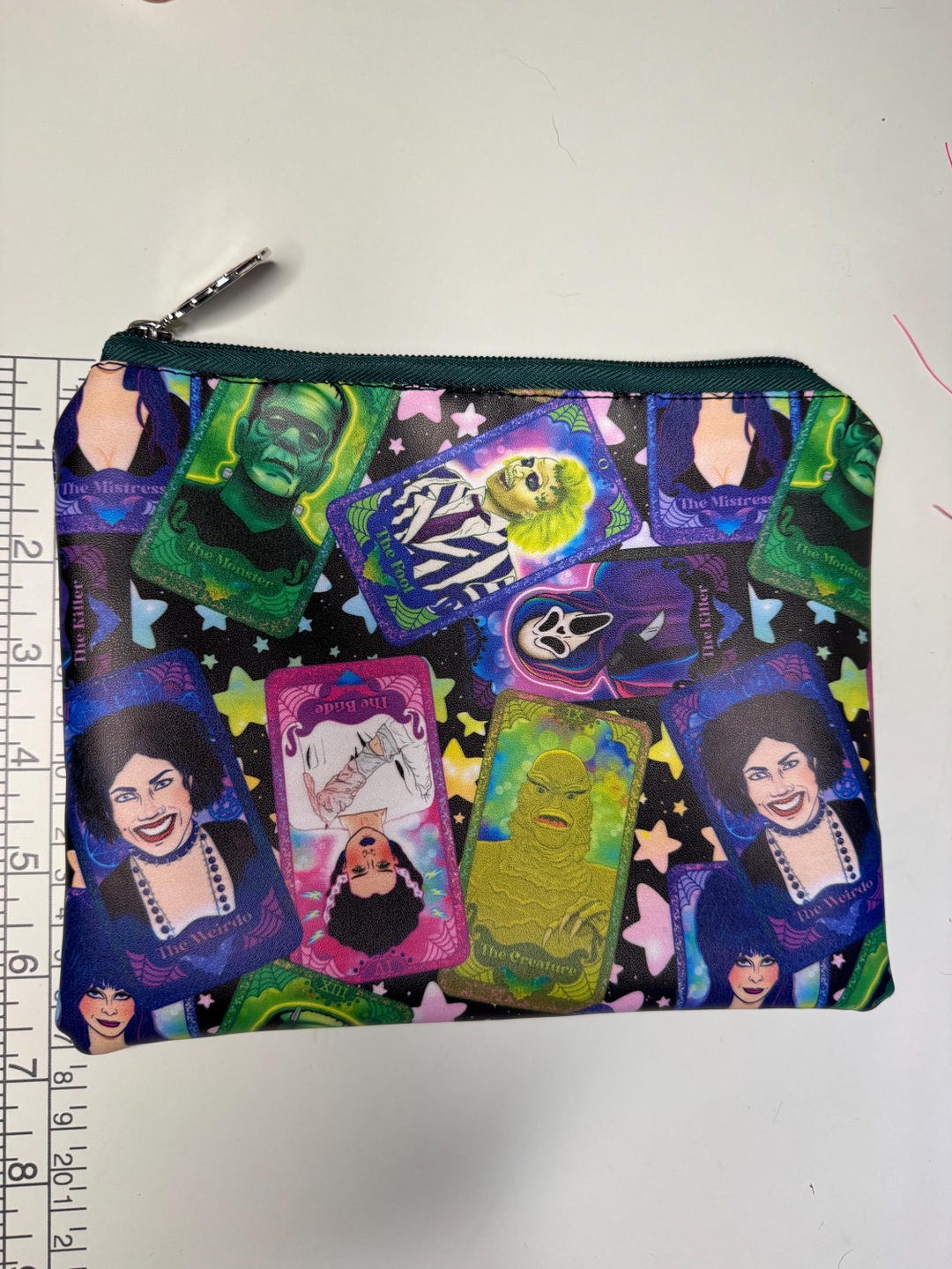Horror movie tarot print zipper pouch with monster tarot cards on a starry black background