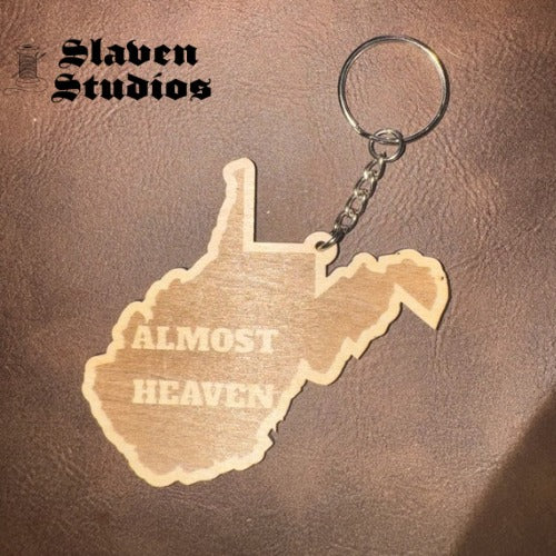 Wooden West Virginia state-shaped keychain laser engraved with Almost Heaven